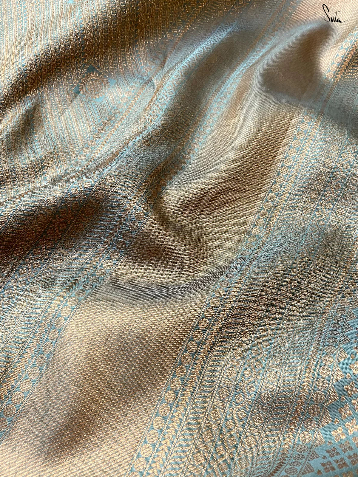 Close-up of textured fabric with intricate patterns and colors.