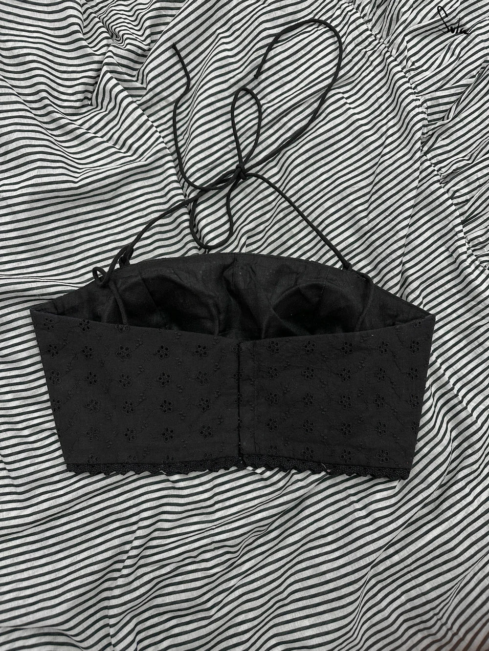 Black blouse against a striped background