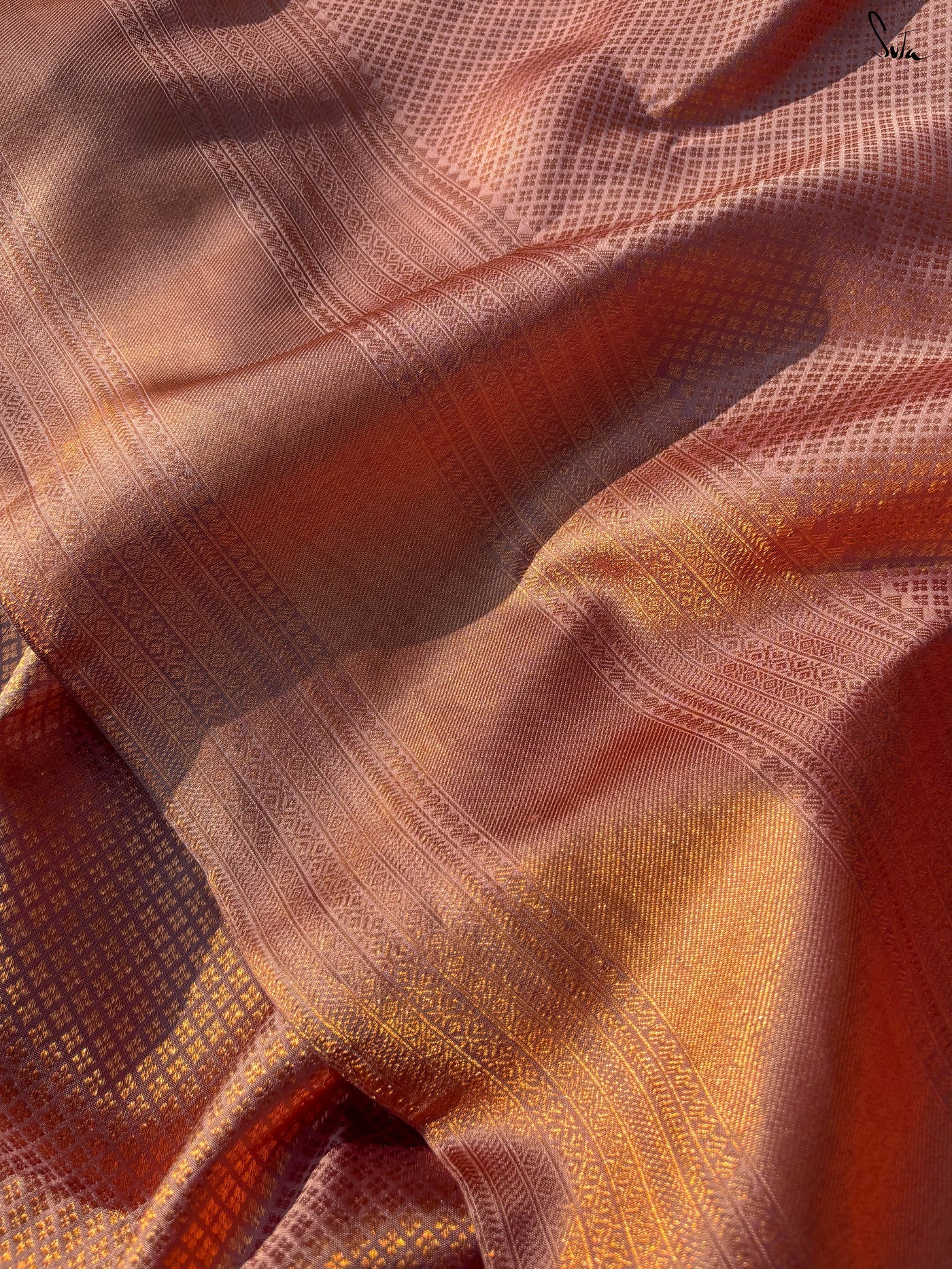 Close-up of red and gold checkered fabric with a subtle pattern.