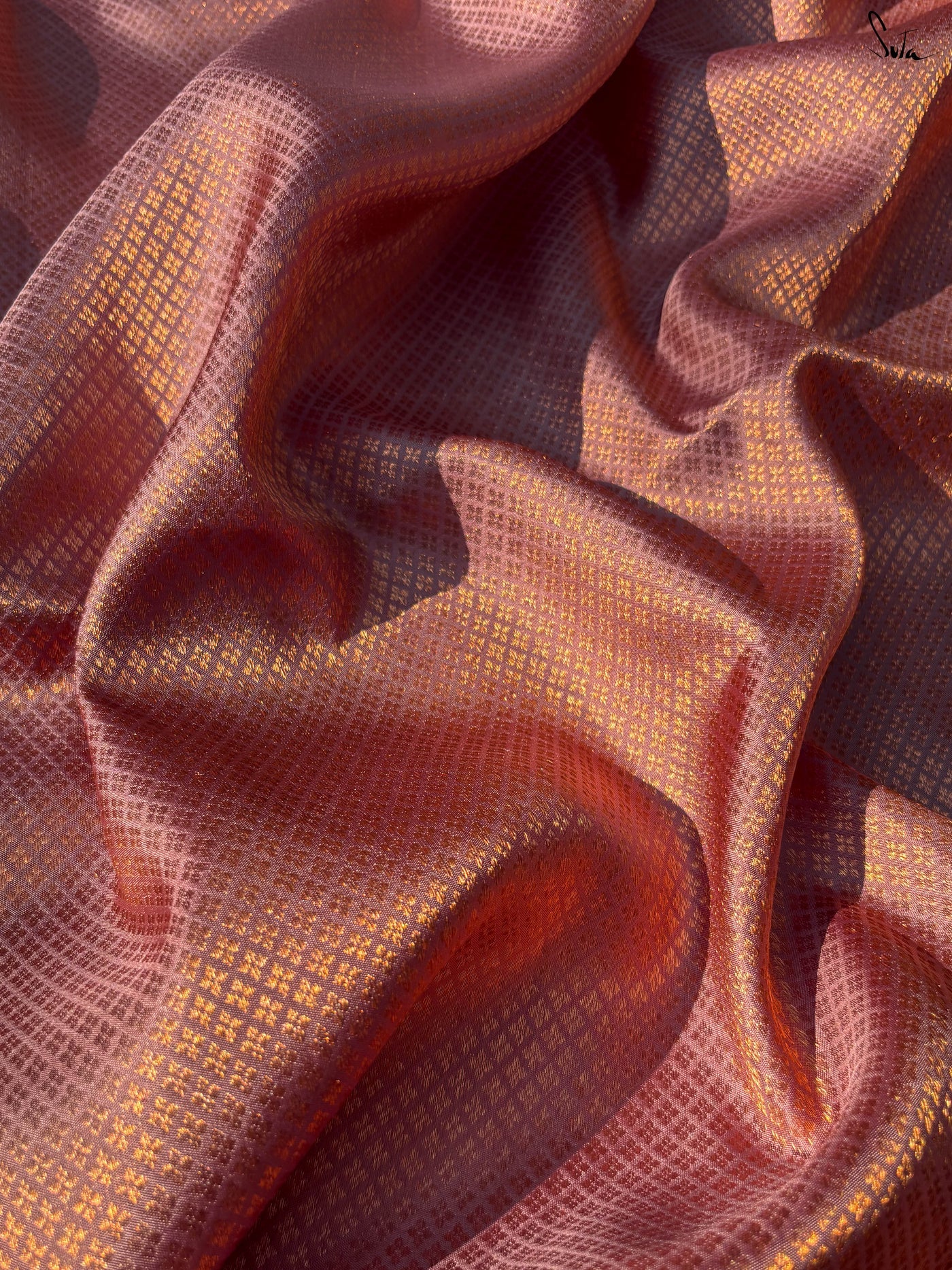Close-up of textured red silk fabric with a pattern