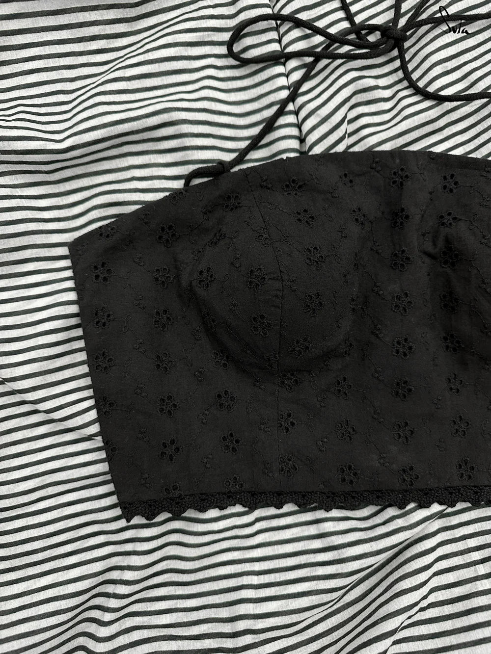 Black blouse on a striped fabric background