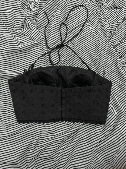 Black blouse against a striped background