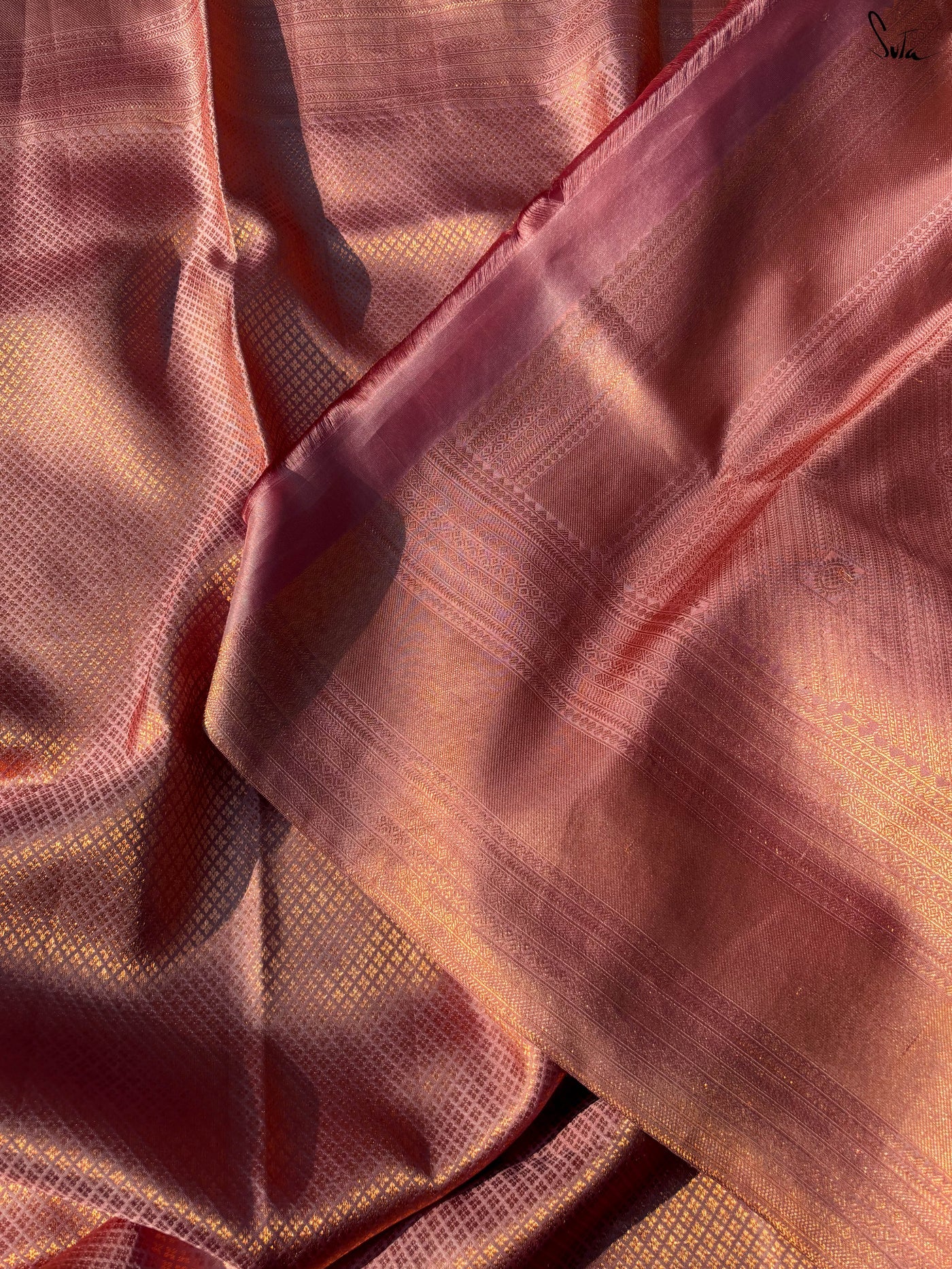 Close-up of pinkish fabric with a textured pattern