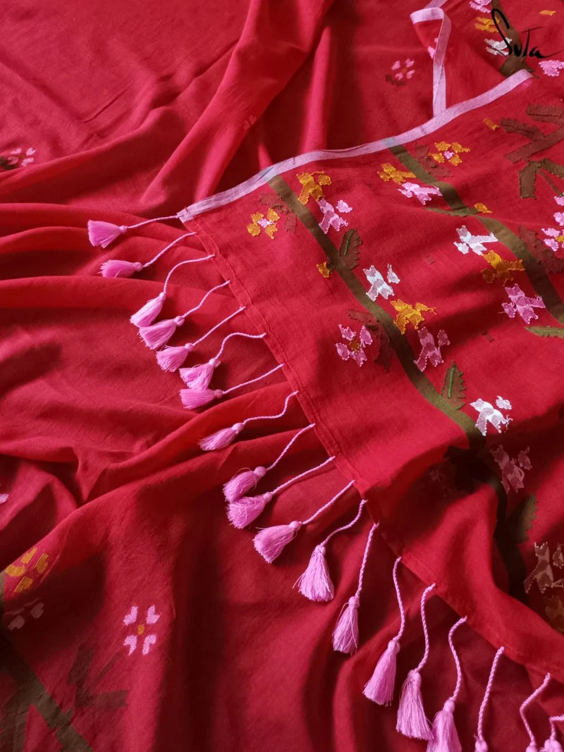 Red fabric with floral embroidery and tassels