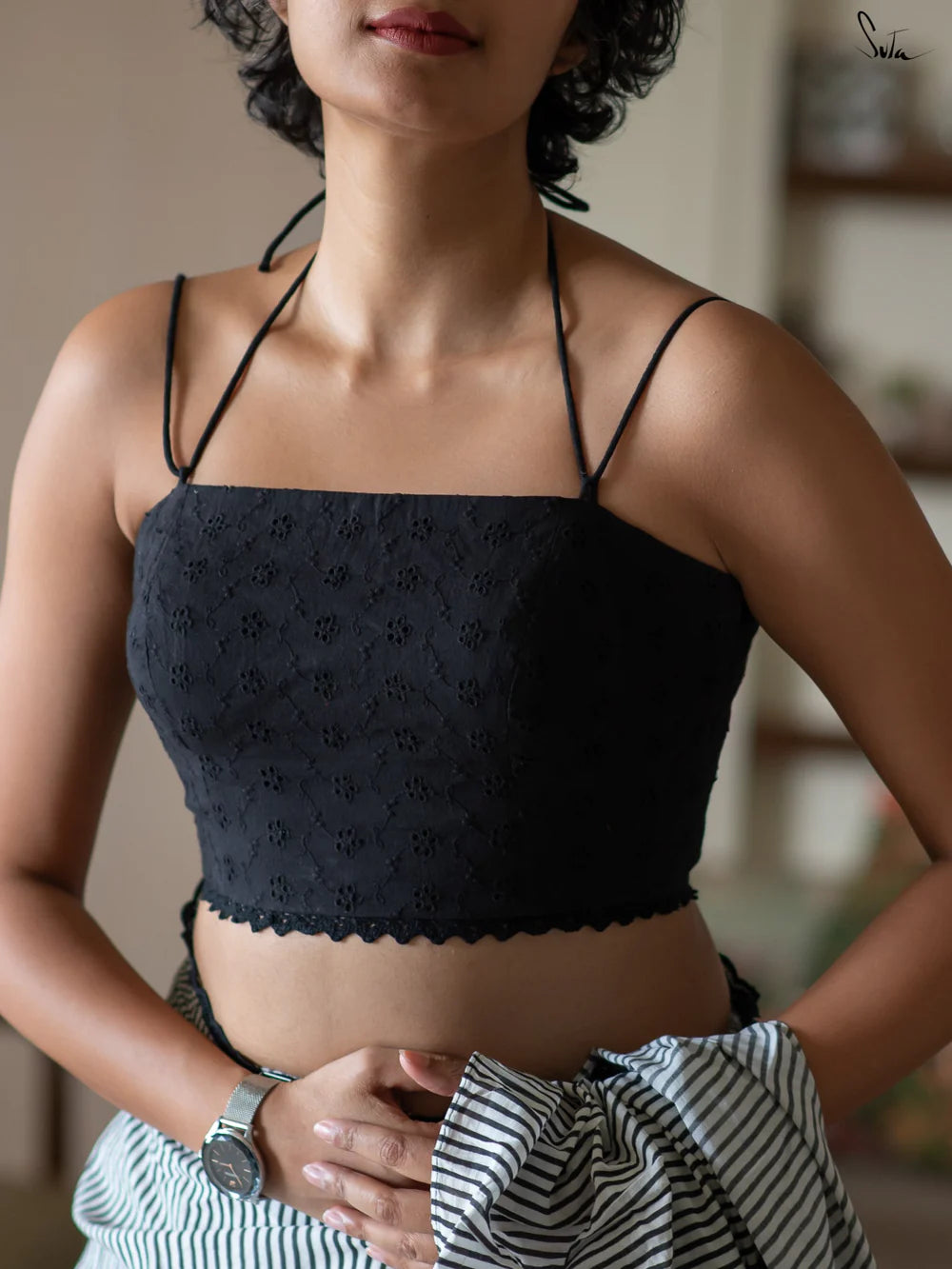 Woman wearing a black blouse with a blurred background