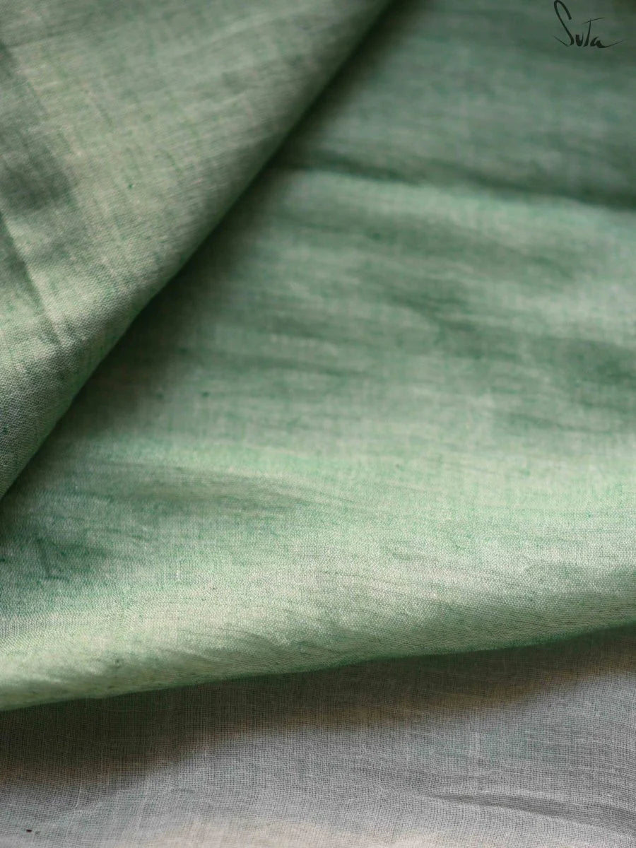Close-up of green fabric with a subtle weave pattern